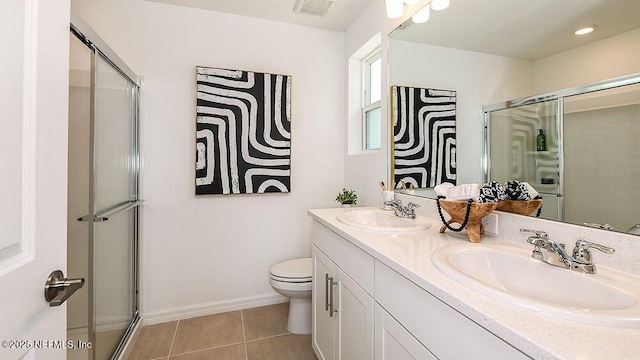 bathroom with toilet, a shower with door, vanity, and tile patterned flooring