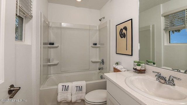 full bathroom with shower / tub combination, vanity, and toilet