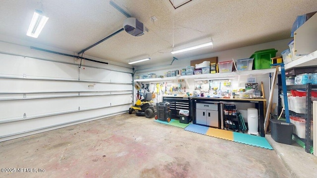 garage featuring a garage door opener and a workshop area