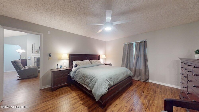 bedroom with hardwood / wood-style floors, a textured ceiling, and ceiling fan