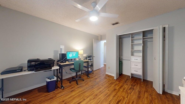 office featuring ceiling fan, hardwood / wood-style flooring, and a textured ceiling