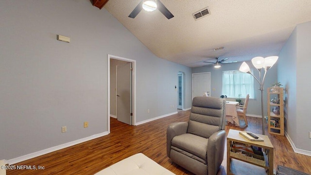 sitting room with hardwood / wood-style flooring, ceiling fan, lofted ceiling, and a textured ceiling