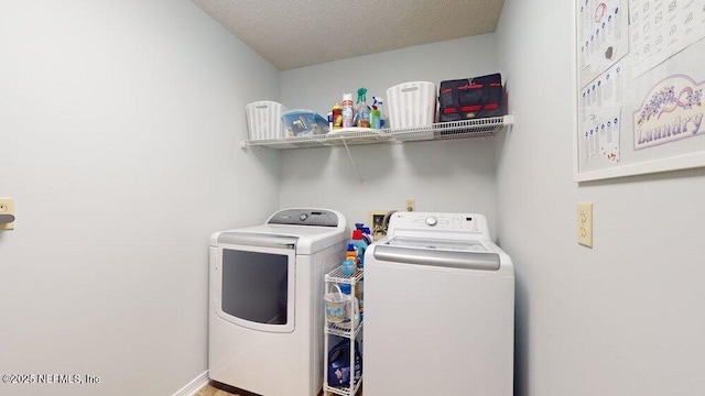 washroom with separate washer and dryer and a textured ceiling