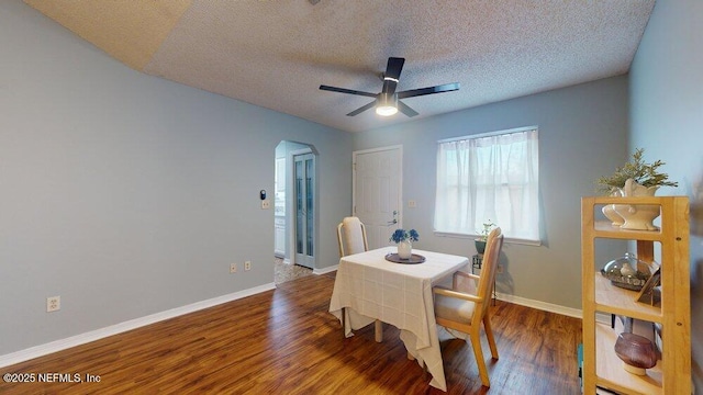 dining room featuring hardwood / wood-style floors, a textured ceiling, and ceiling fan