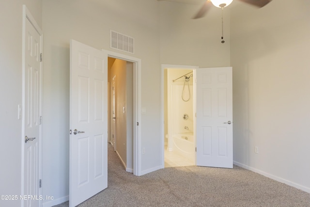 unfurnished bedroom with light colored carpet and ensuite bath