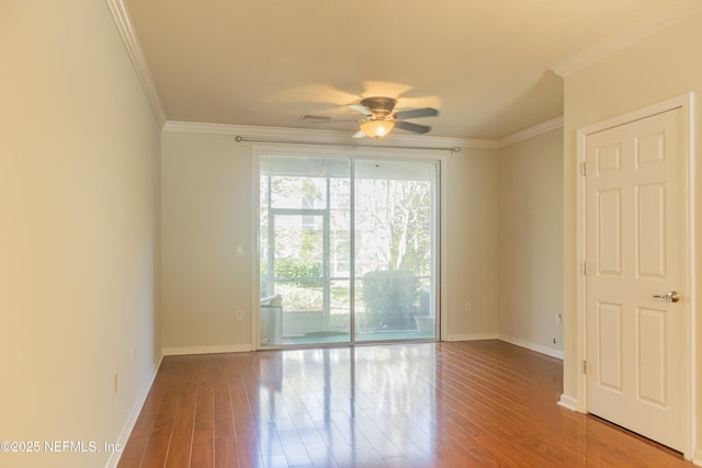 spare room with crown molding, ceiling fan, and hardwood / wood-style flooring