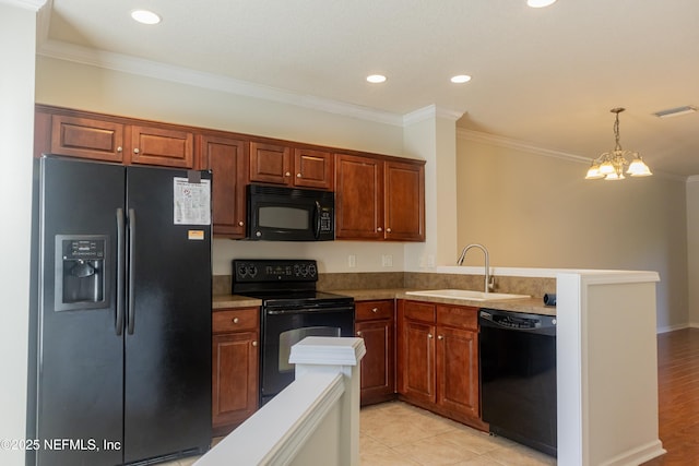 kitchen with ornamental molding, sink, hanging light fixtures, and black appliances