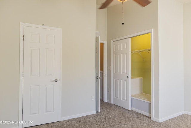 unfurnished bedroom with light carpet, high vaulted ceiling, and a closet