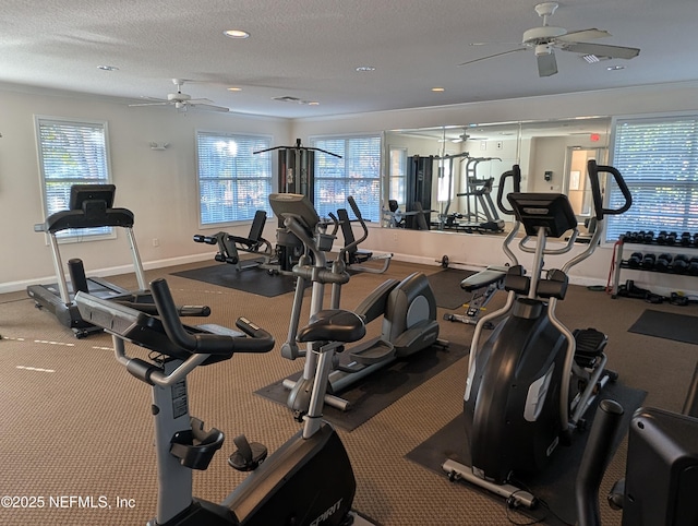 exercise room featuring ceiling fan, carpet floors, and a textured ceiling