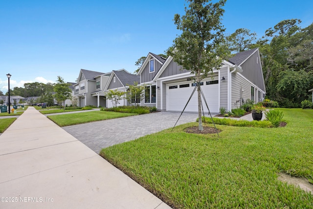 view of front facade with a garage and a front lawn