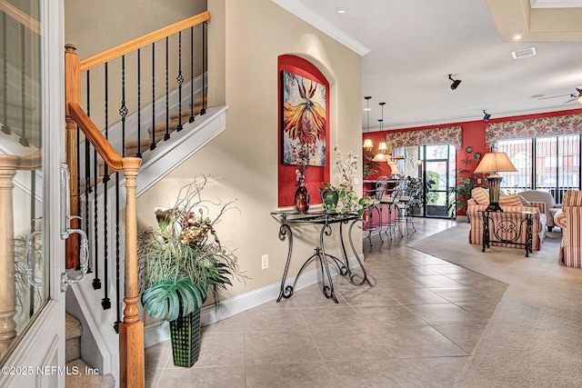 tiled foyer with baseboards, visible vents, ceiling fan, stairway, and ornamental molding