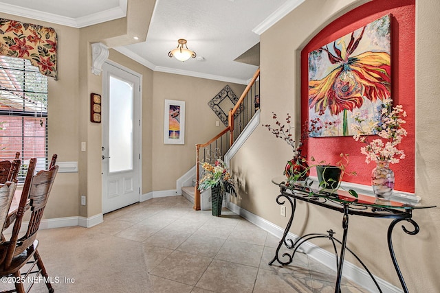 tiled foyer entrance featuring baseboards, stairs, and ornamental molding