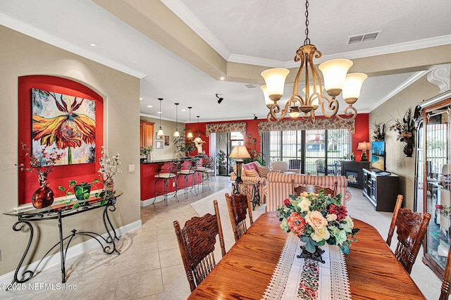 dining space with a chandelier, plenty of natural light, visible vents, and crown molding