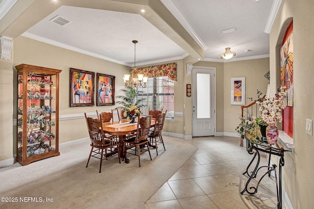 dining room featuring light tile patterned floors, a textured ceiling, visible vents, and crown molding