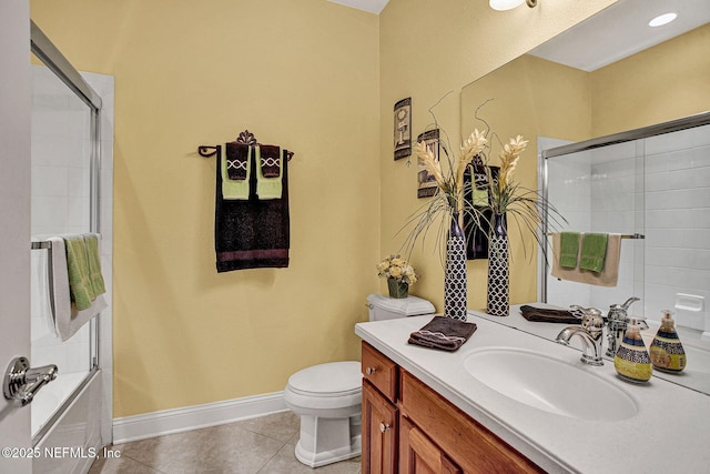 bathroom with toilet, combined bath / shower with glass door, vanity, tile patterned flooring, and baseboards