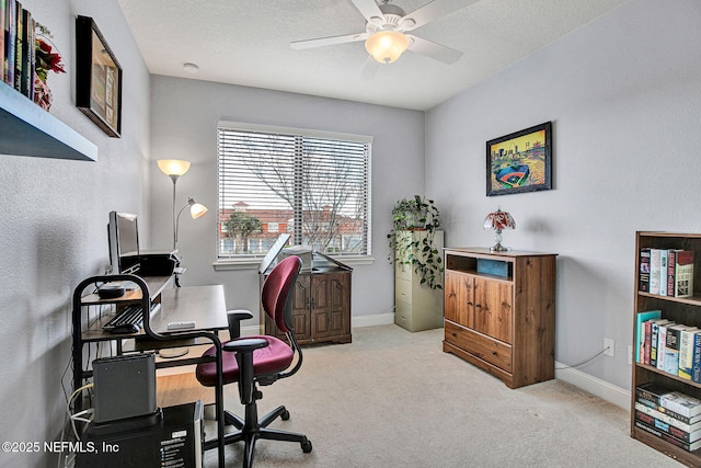 office space with carpet, baseboards, and ceiling fan