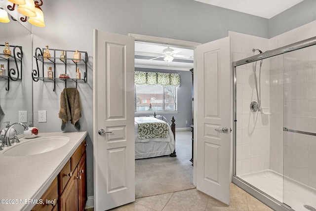 full bath with ensuite bathroom, a stall shower, ceiling fan, vanity, and tile patterned flooring