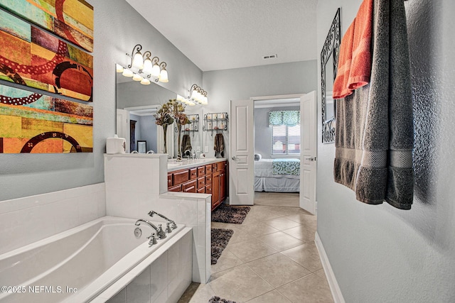 bathroom with ensuite bathroom, a garden tub, tile patterned flooring, a textured ceiling, and vanity