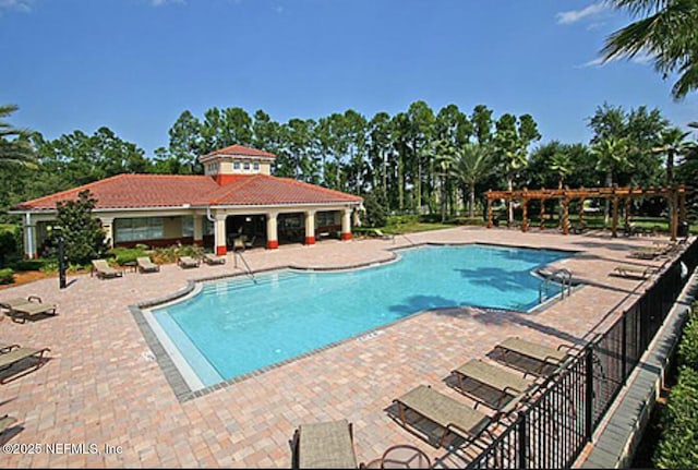 community pool featuring a patio area, fence, and a pergola