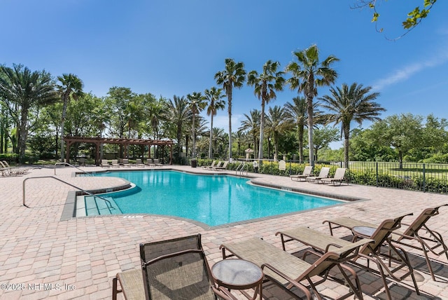 pool featuring a patio area, fence, and a pergola