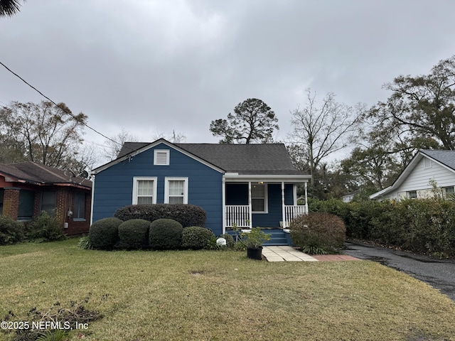 bungalow with a front yard and covered porch