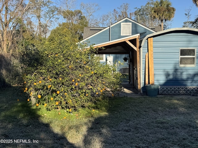 view of side of home featuring a lawn