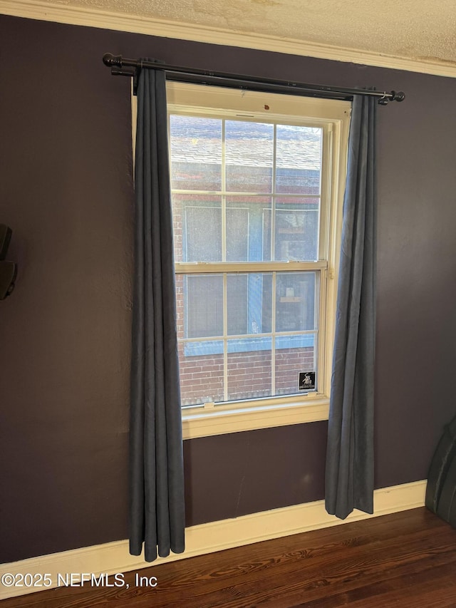 details with hardwood / wood-style flooring and ornamental molding