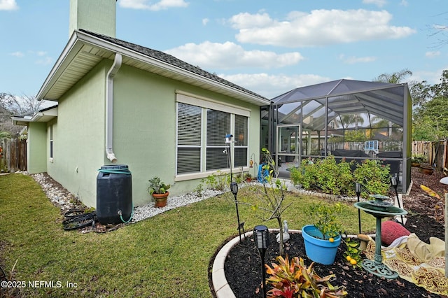 view of side of home featuring a yard and glass enclosure