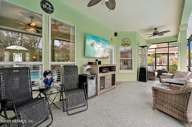 sunroom featuring ceiling fan