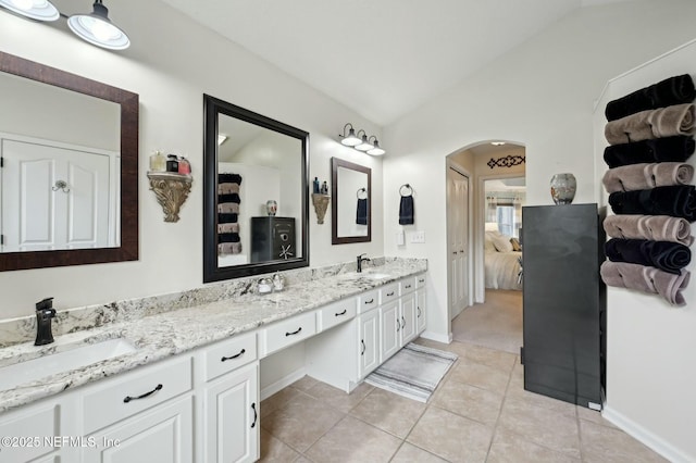 bathroom with vanity, tile patterned flooring, and vaulted ceiling