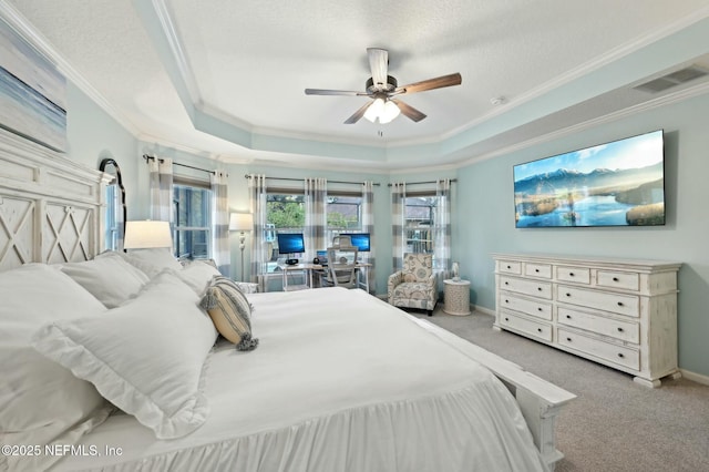 bedroom featuring crown molding, ceiling fan, a tray ceiling, a textured ceiling, and light carpet