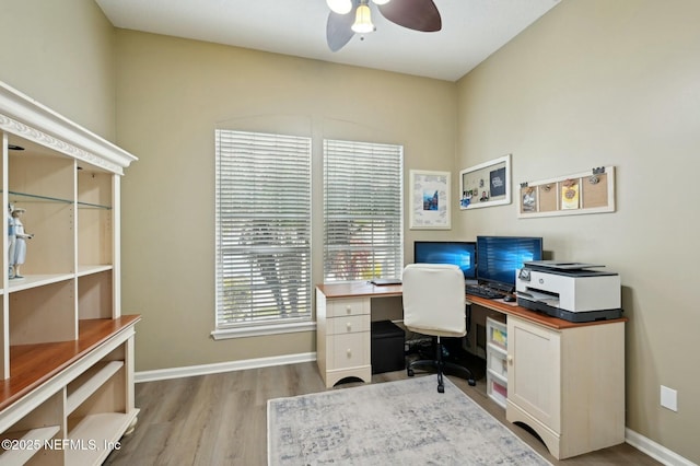 home office with ceiling fan and light wood-type flooring