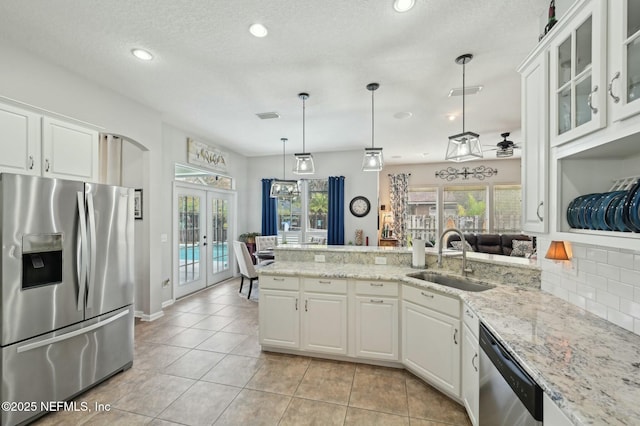 kitchen with french doors, sink, decorative light fixtures, stainless steel appliances, and white cabinets