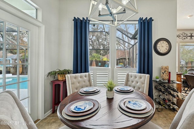 dining room featuring tile patterned flooring and a notable chandelier