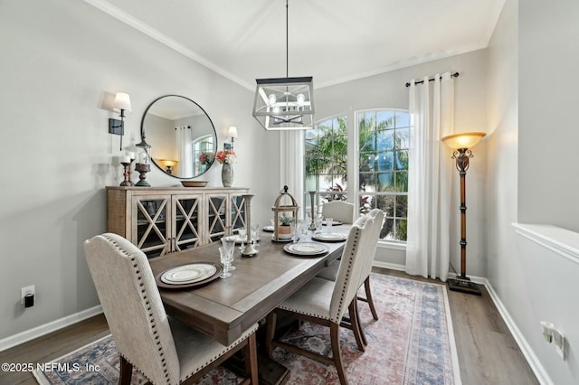 dining area featuring ornamental molding, hardwood / wood-style floors, and a chandelier