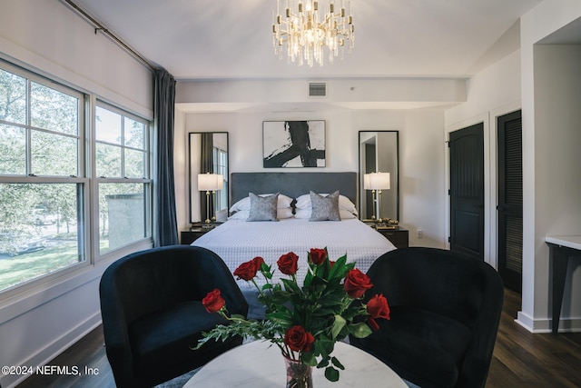 bedroom featuring dark hardwood / wood-style floors and a chandelier