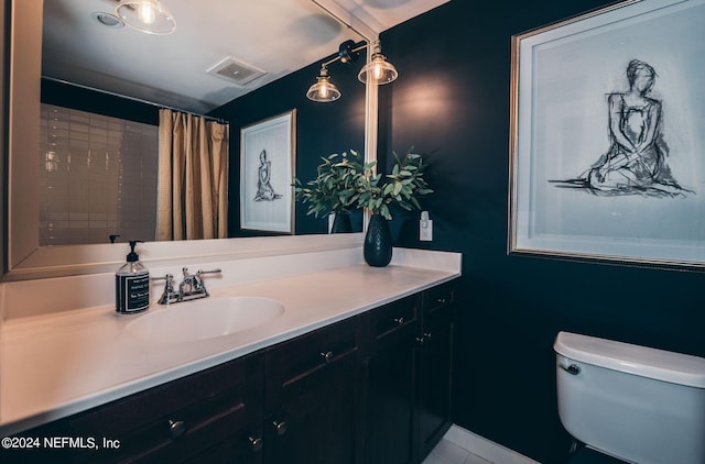 bathroom featuring curtained shower, toilet, and vanity