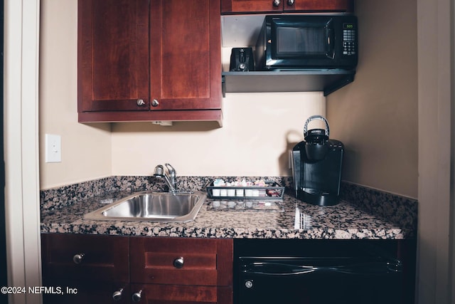 kitchen featuring sink and dark stone countertops