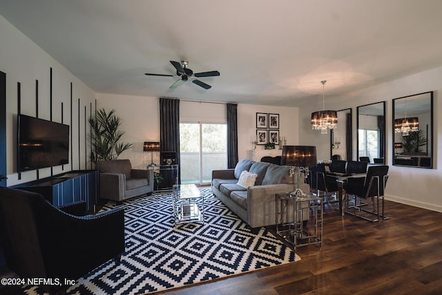 living room with hardwood / wood-style flooring and ceiling fan with notable chandelier