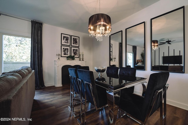 dining area with hardwood / wood-style floors and ceiling fan with notable chandelier