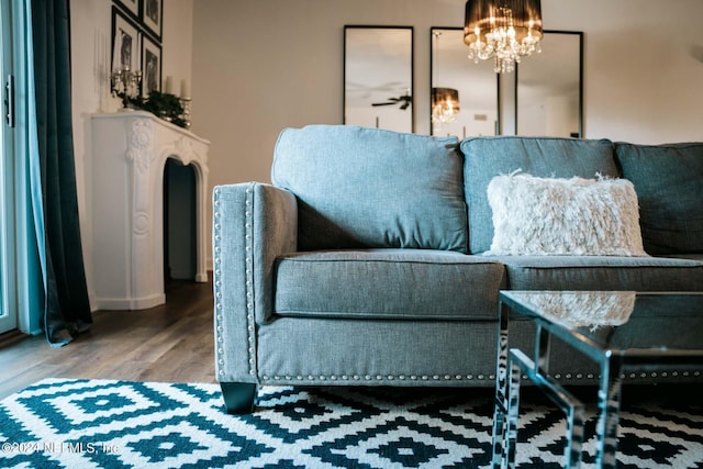 living room featuring hardwood / wood-style floors and an inviting chandelier