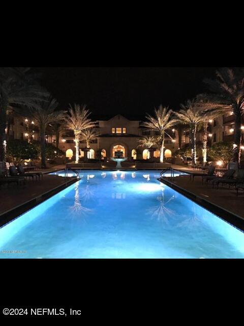 view of pool at night