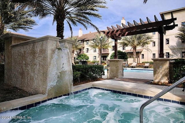 view of swimming pool with a pergola