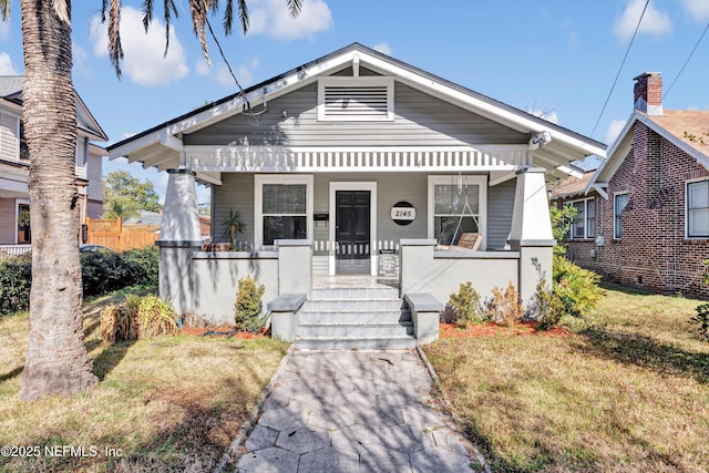 bungalow-style house with a front lawn and a porch