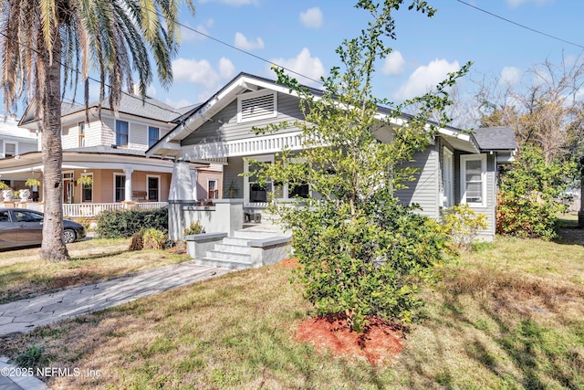 view of front of home featuring a front yard and covered porch