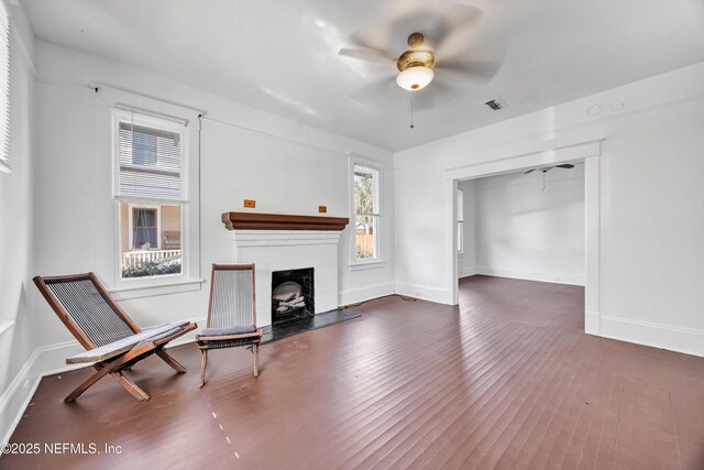 living room with ceiling fan and dark hardwood / wood-style flooring