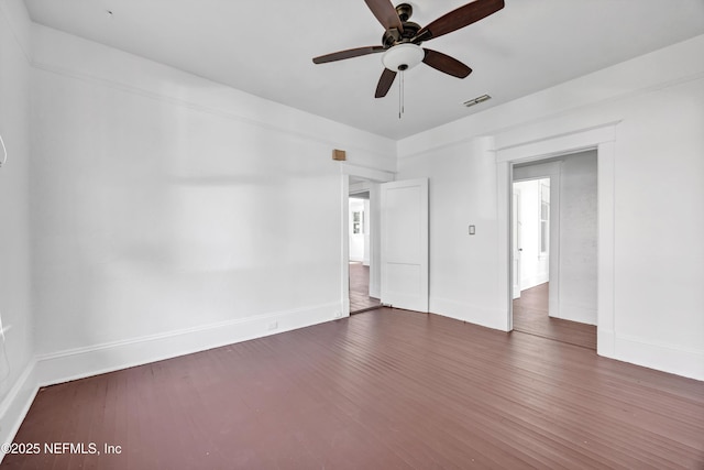 unfurnished room featuring ceiling fan and dark hardwood / wood-style flooring