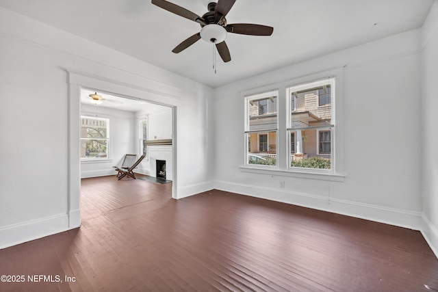 empty room featuring ceiling fan and dark hardwood / wood-style flooring