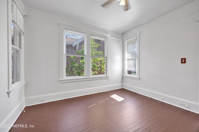 unfurnished room with dark wood-type flooring and ceiling fan