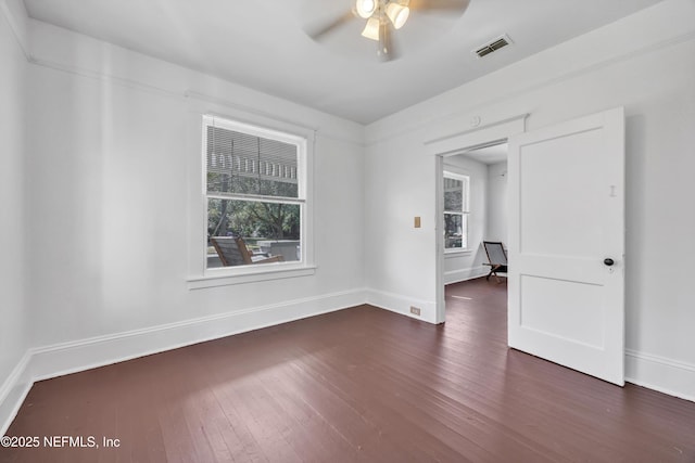 empty room featuring dark hardwood / wood-style floors and ceiling fan